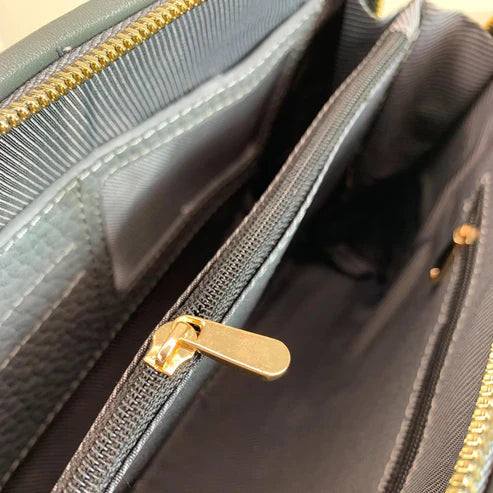 Elegant gray leather clutch bag by LeatherLuxe, featuring a minimalist design with detachable crossbody strap, premium stitching, and gold-tone hardware.
