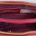 Elegant dark red genuine leather clutch bag with shoulder strap and crossbody design — LeatherLuxe premium women’s handbag