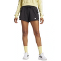 Person wearing black Adidas shorts and a light yellow sweatshirt on a white background