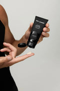 Virtue men’s skincare set with cleanser, exfoliator, moisturizer, face mask, and serum in sleek black packaging displayed with male models