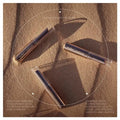 Three lip products on a textured surface with 'nuda natura' branding.