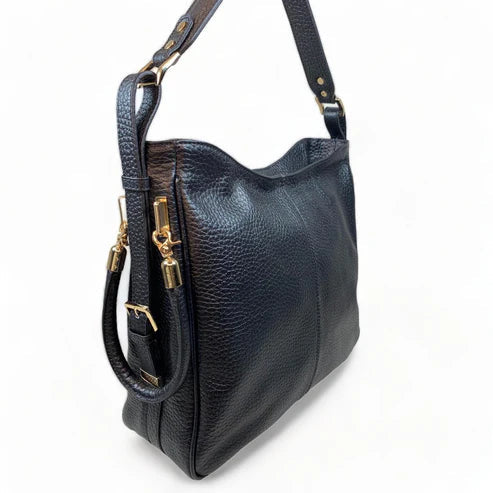 Black genuine leather tote bag with premium craftsmanship, minimalist design, and spacious interior from LeatherLuxe.