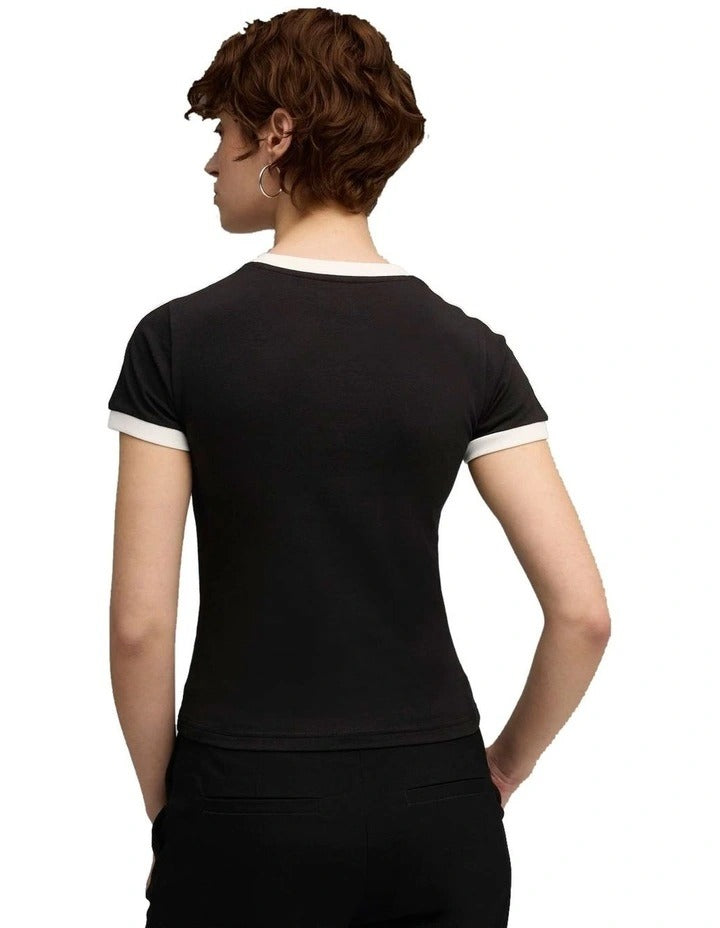 Person wearing a black Puma t-shirt holding a white duffel bag on a white background