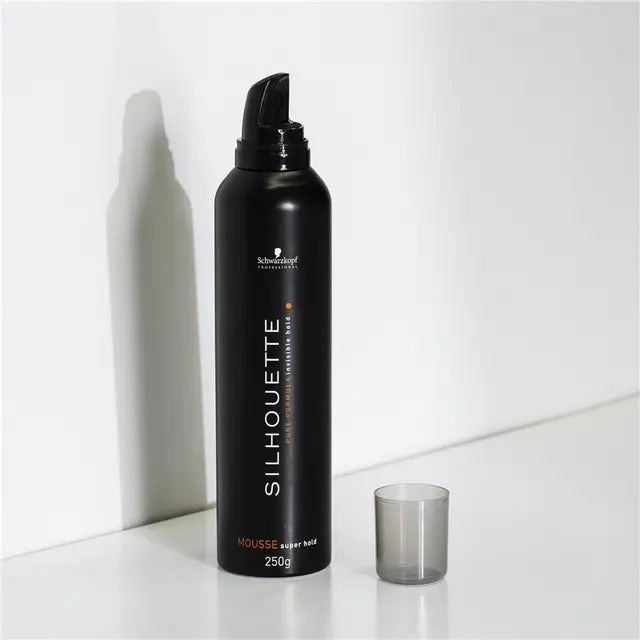 Black bottle of Schwarzkopf Silhouette hair mousse on a white background