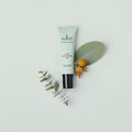 Sukin skincare tube with natural elements on a light background