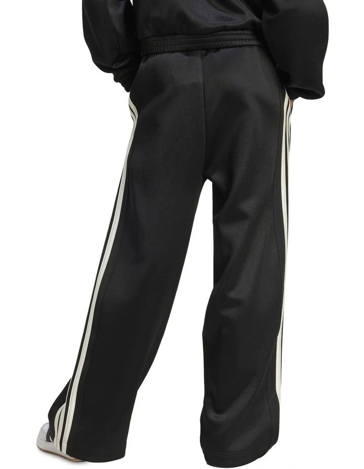 Black tracksuit with white stripes and Adidas logo on a white background