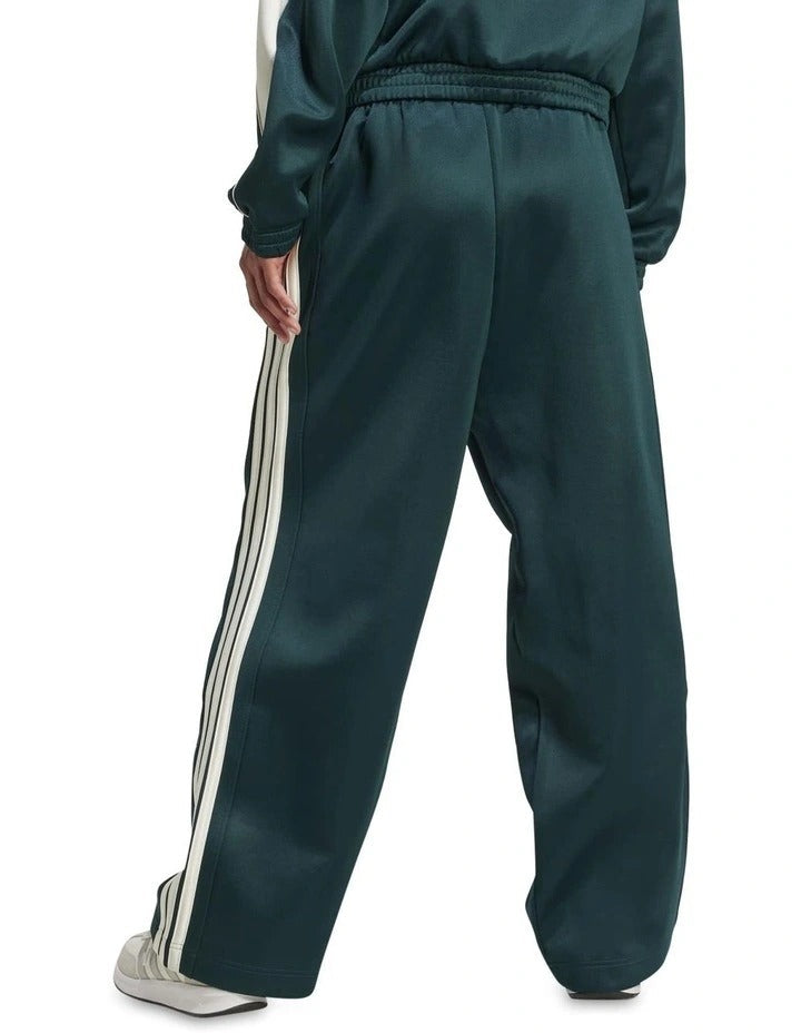 Green Adidas tracksuit with white stripes on a white background